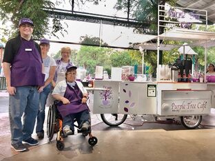 Photo of Purple Tree employees at bike-powered coffee cart.